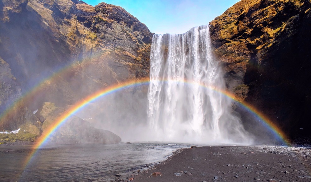Skógafoss waterfall in Iceland with rainbow